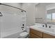 Bright bathroom boasts a shower-tub combo, elegant vanity, and modern fixtures at 21553 W Pierson St, Buckeye, AZ 85396