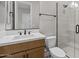 Modern bathroom showcasing a frameless glass shower, stylish vanity, and refined design elements at 21553 W Pierson St, Buckeye, AZ 85396