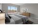 Bright bedroom featuring a large window with outside views, complemented by light gray walls and modern décor at 21553 W Pierson St, Buckeye, AZ 85396