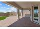 Inviting covered patio featuring brick pavers and a neutral color palette, perfect for outdoor relaxation at 21553 W Pierson St, Buckeye, AZ 85396