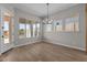 Bright dining area features wood-look flooring and large windows, perfect for enjoying Gathering meals with a view at 21553 W Pierson St, Buckeye, AZ 85396