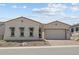 Charming single-story home featuring a stucco facade, a two-car garage, and a well-maintained front yard at 21553 W Pierson St, Buckeye, AZ 85396
