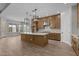 Spacious kitchen with a center island, stainless steel appliances, stylish pendant lighting, and ample counter space at 21553 W Pierson St, Buckeye, AZ 85396