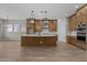 Open concept kitchen with a large island, stainless appliances, and custom cabinets is ideal for entertaining at 21553 W Pierson St, Buckeye, AZ 85396