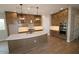 Modern kitchen with a large island, stainless steel appliances, pendant lighting, and ample cabinet space at 21553 W Pierson St, Buckeye, AZ 85396