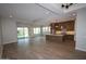 Bright open-concept living space with wood-look tile floors, recessed lighting, and a seamless flow to the kitchen at 21553 W Pierson St, Buckeye, AZ 85396