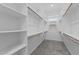 Spacious walk-in closet featuring ample shelving and hanging space for organized storage solutions at 21553 W Pierson St, Buckeye, AZ 85396