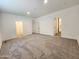 Spacious bedroom with plush carpeting and an attached closet and bathroom at 301 N Brower Rd, Maricopa, AZ 85139