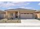 Charming single-story home featuring a low-maintenance yard, a neutral color palette, and a two-car garage at 24586 W St Anne Ave, Buckeye, AZ 85326
