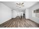 Open living room featuring vinyl wood flooring and natural light from a large window at 24586 W St Anne Ave, Buckeye, AZ 85326