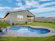 Inviting kidney shaped pool with grassy backyard and patio at 30564 N Sydney Dr, San Tan Valley, AZ 85143