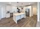 Modern kitchen with stainless steel appliances, white cabinetry and a large center island at 310 N Brower Rd, Maricopa, AZ 85139