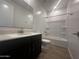 Well-lit bathroom featuring a vanity with modern fixtures and a shower-tub combination at 4301 E Bradford Ave, San Tan Valley, AZ 85143