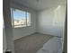 Well-lit bedroom with neutral carpeting and a large window at 4301 E Bradford Ave, San Tan Valley, AZ 85143