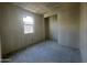 Unfinished bedroom with single window and closet at 4301 E Bradford Ave, San Tan Valley, AZ 85143