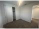 Clean, carpeted bedroom with a closet and a view into the hallway at 4301 E Bradford Ave, San Tan Valley, AZ 85143