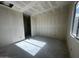 Unfinished bedroom with window and textured walls at 4301 E Bradford Ave, San Tan Valley, AZ 85143