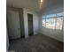 Carpeted bedroom with a window and closet, offering ample natural light at 4301 E Bradford Ave, San Tan Valley, AZ 85143