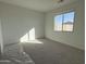 Bright bedroom with carpeted floor and large window at 4301 E Bradford Ave, San Tan Valley, AZ 85143