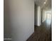 Bright hallway with wood-look tile floors and neutral walls, leading to the living spaces at 4301 E Bradford Ave, San Tan Valley, AZ 85143