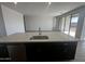 Spacious kitchen island featuring sleek cabinetry, a modern sink, and stainless steel appliances at 4301 E Bradford Ave, San Tan Valley, AZ 85143