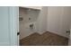 Convenient laundry room with upper cabinets and tile flooring at 4301 E Bradford Ave, San Tan Valley, AZ 85143