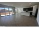 Open-concept living space with tile flooring, large windows and glass doors leading to the backyard at 4301 E Bradford Ave, San Tan Valley, AZ 85143