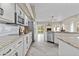 Bright kitchen featuring white cabinetry, granite countertops, stainless steel appliances, and backyard access at 16686 S 18Th Way, Phoenix, AZ 85048