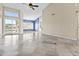 Spacious living area featuring tiled floors, high ceilings, and sliding glass doors that lead to an outdoor space at 16686 S 18Th Way, Phoenix, AZ 85048