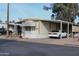 Home exterior showing a long carport and manicured cacti at 9333 E University Dr # 89, Mesa, AZ 85207