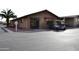 View of game room, with a golf cart parked outside, and desert landscape at 9333 E University Dr # 89, Mesa, AZ 85207