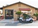 Exterior view of the well-maintained game room, featuring a golf cart and desert landscaping at 9333 E University Dr # 89, Mesa, AZ 85207