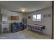 A well-equipped laundry room featuring modern washer and dryer, utility sink, and a water heater at 12441 W Morning Dove Dr, Sun City West, AZ 85375