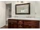 Bathroom with double vanity, marble countertop, and a framed mirror at 13128 N 104Th Pl, Scottsdale, AZ 85260