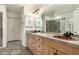 Bathroom with double vanity, copper sinks, and a large walk-in shower at 13128 N 104Th Pl, Scottsdale, AZ 85260