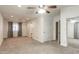 Bright bedroom with ceiling fan, carpet, and mirrored closet doors at 13128 N 104Th Pl, Scottsdale, AZ 85260