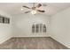 Spacious bedroom featuring a ceiling fan and arched window with shutters at 13128 N 104Th Pl, Scottsdale, AZ 85260