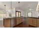 Modern kitchen with island, stainless steel appliances, and wood cabinets at 13128 N 104Th Pl, Scottsdale, AZ 85260