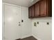 Laundry room with wood cabinets and tile floor at 13128 N 104Th Pl, Scottsdale, AZ 85260