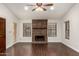 Living room with stone fireplace and hardwood floors at 13128 N 104Th Pl, Scottsdale, AZ 85260