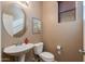 Clean bathroom with pedestal sink and toilet at 2090 S Moccasin Trl, Gilbert, AZ 85295