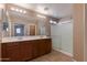 Double vanity bathroom with large mirror and shower at 2090 S Moccasin Trl, Gilbert, AZ 85295