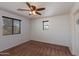 Bright bedroom featuring ceiling fan and neutral carpeting at 2090 S Moccasin Trl, Gilbert, AZ 85295