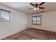 Spacious bedroom with two windows and carpet flooring at 2090 S Moccasin Trl, Gilbert, AZ 85295