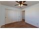 Bedroom with double-door closet and ceiling fan at 2090 S Moccasin Trl, Gilbert, AZ 85295