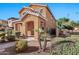 Two-story tan house with landscaped yard and walkway at 2090 S Moccasin Trl, Gilbert, AZ 85295