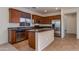 Open kitchen with island, stainless steel appliances, and granite countertops at 2090 S Moccasin Trl, Gilbert, AZ 85295