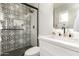 Modern bathroom with a patterned shower, white vanity, and gold fixtures at 2507 E Buffalo St, Chandler, AZ 85225