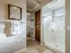 Bright bathroom featuring tiled floors, glass shower, and seamless entry to bedroom at 27587 N Makena Pl, Peoria, AZ 85383