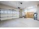 Clean garage equipped with epoxy flooring and workspace perfect for projects and storage at 27587 N Makena Pl, Peoria, AZ 85383